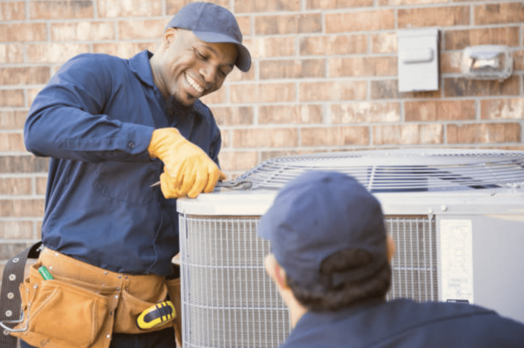 Technician performing proactive maintenance on a residential heat pump system Technician performing proactive maintenance on a residential heat pump system