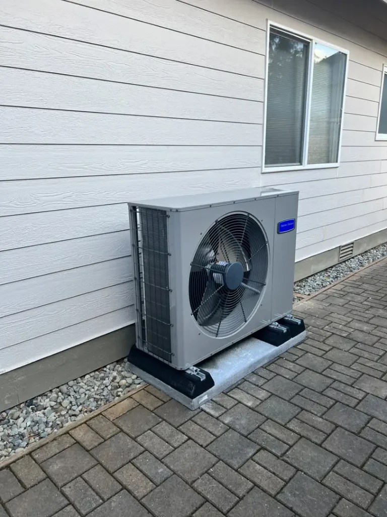 professional technician installing a residential heat pump in a Puyallup home